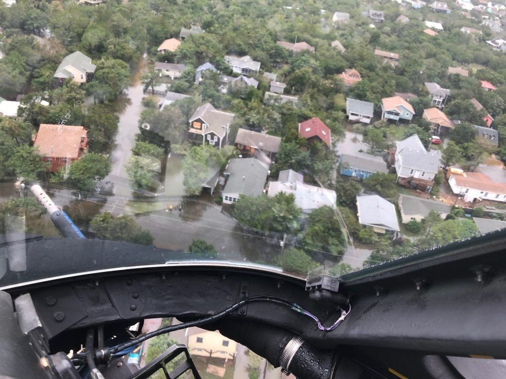 View from a Coast Guard helicopter cockpit over Ocracoke village on 6 September 2019, showing floodwater standing in the streets and yards between houses